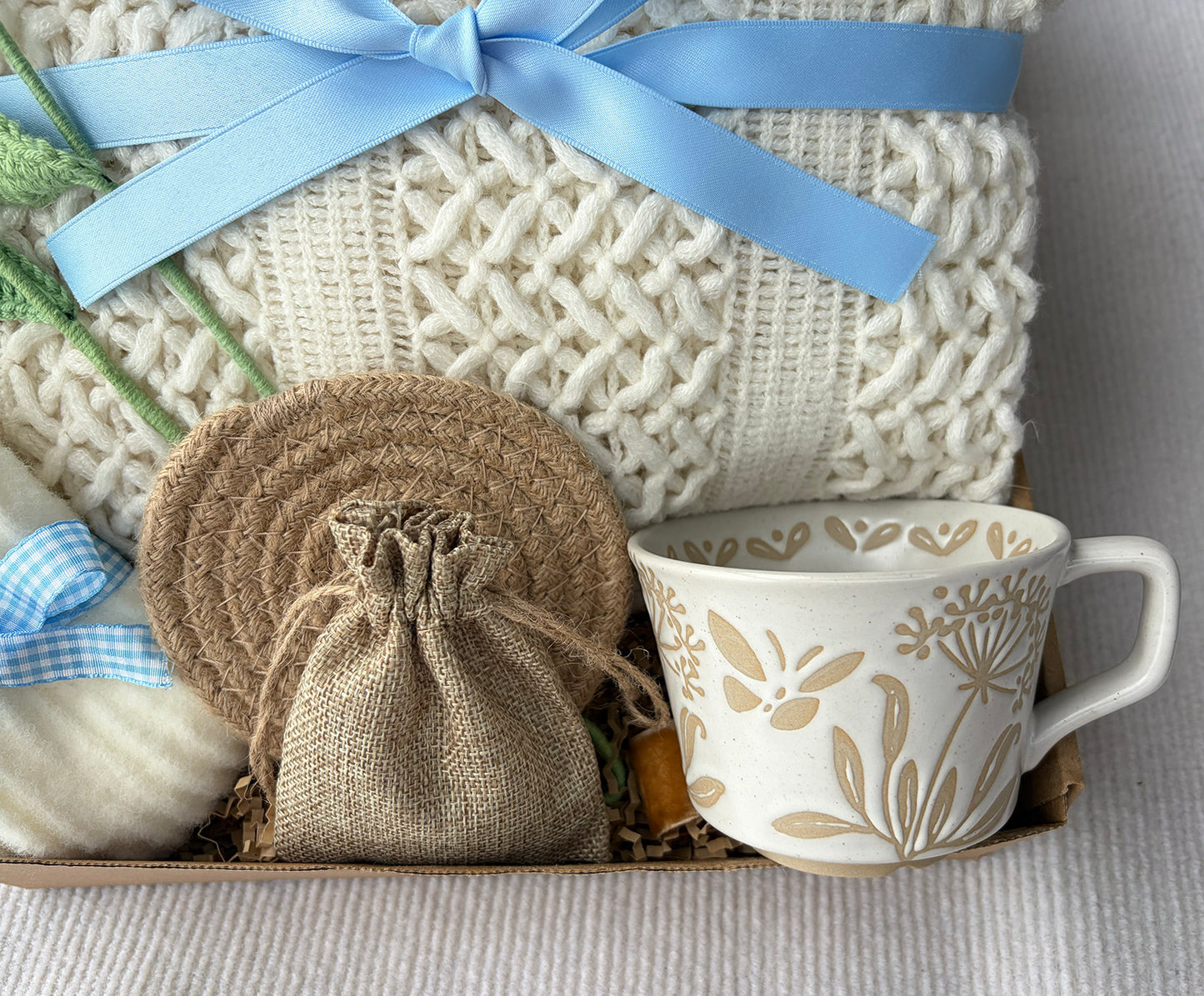 Cream Sky Blue Cozy Gift Basket for Her – Self Care Gift Box with Knit Blanket, Botanical Mug, Fuzzy Socks, Scented Sachet & Crochet Tulips komorebi INC