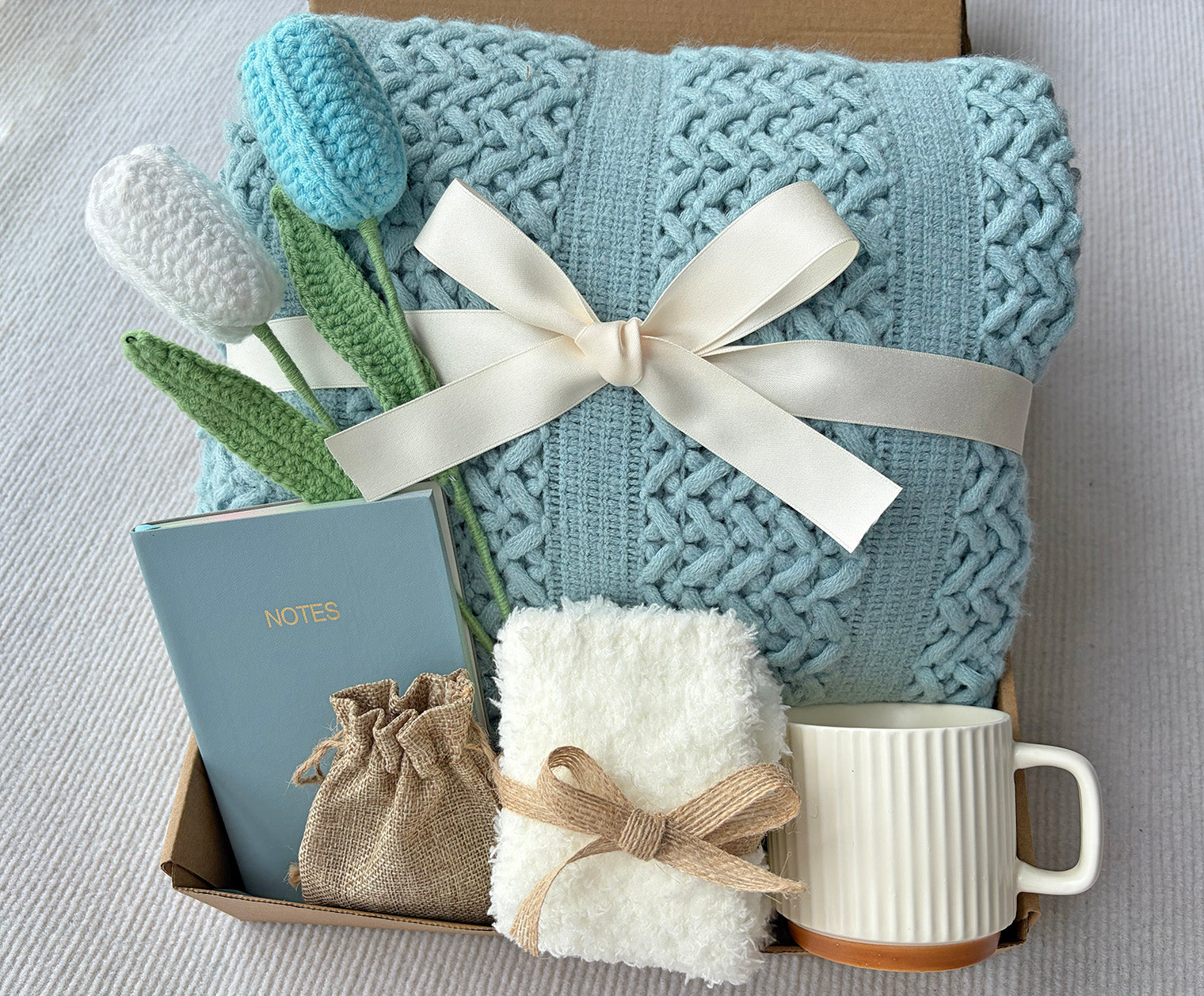 Soft Sky Blue Cozy Gift Box | Cable Knit Blanket, Ceramic Mug, Notebook, Fuzzy Socks, Scent Bag & Crochet Tulip Gift Basket komorebi INC