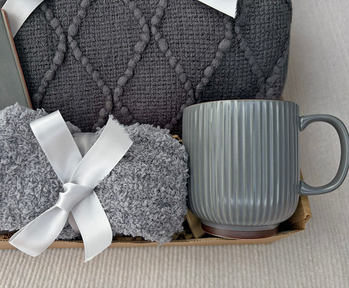 Charcoal Grey Self-Care Gift Basket for Him & Her | Knit Blanket, Ceramic Mug, Fuzzy Socks & Leather Journal Set komorebi INC