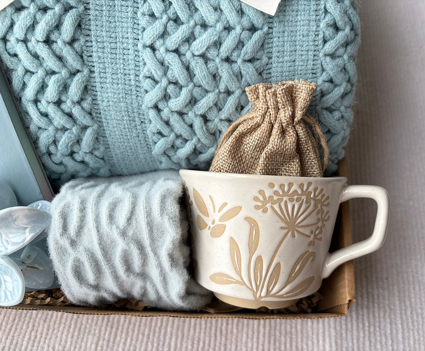 Light Blue Cozy Gift Basket for Her – Self Care Gift Box with Knit Blanket, Botanical Mug, Fuzzy Socks, Notebook, Scented Sachet & Floral Hair Clip komorebi INC