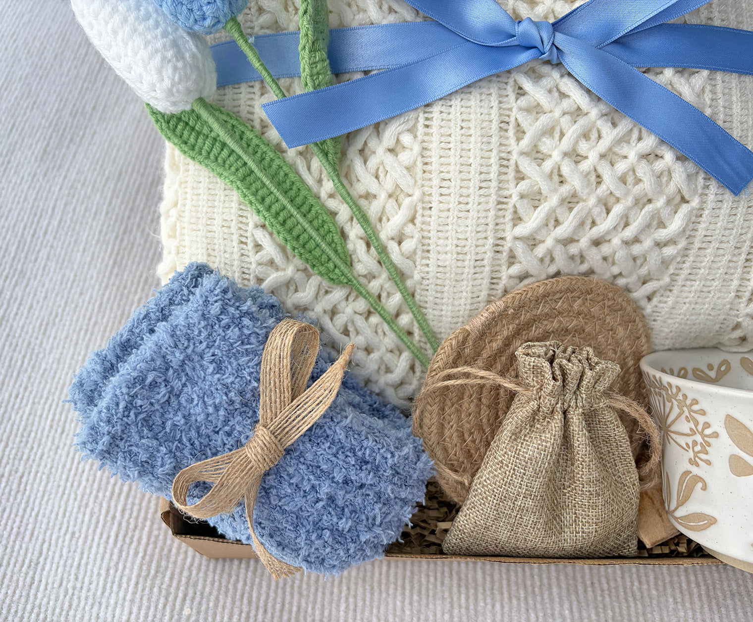 Cream Sky Blue Cozy Gift Basket for Her – Self Care Gift Box with Knit Blanket, Botanical Mug, Fuzzy Socks, Scented Sachet & Crochet Tulips komorebi INC