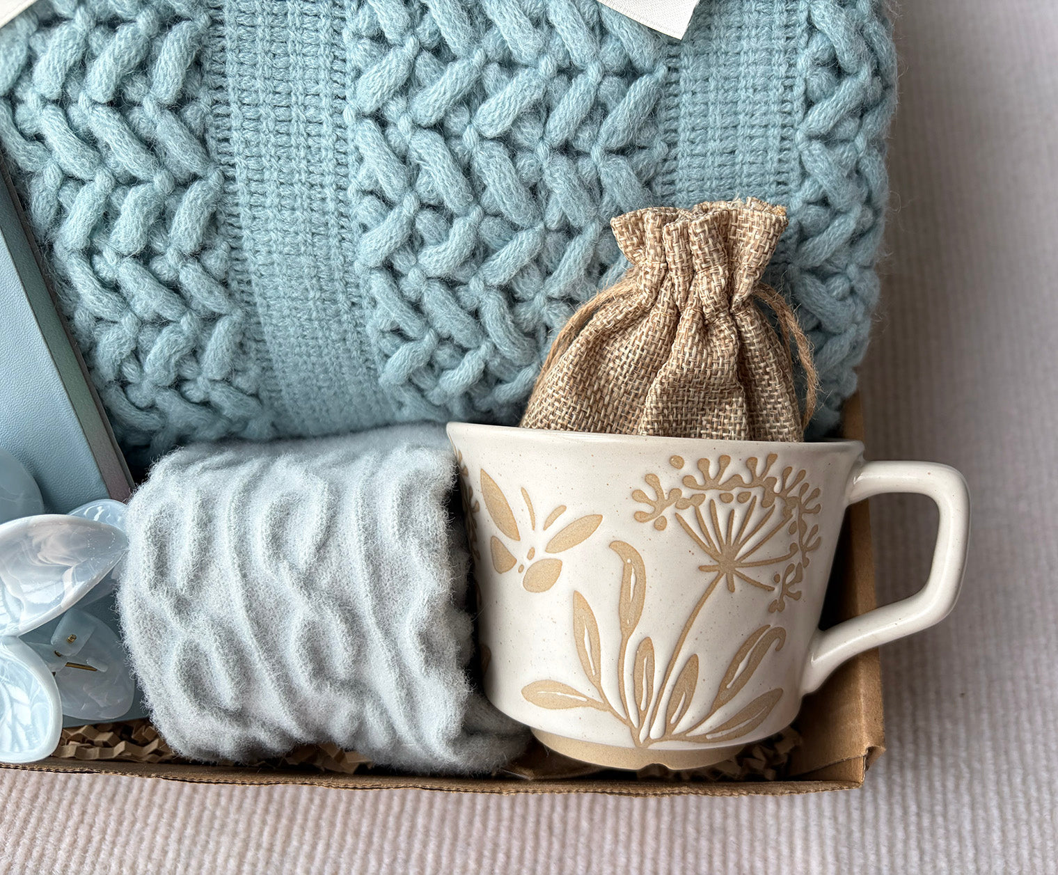 Light Blue Cozy Gift Basket for Her – Self Care Gift Box with Knit Blanket, Botanical Mug, Fuzzy Socks, Notebook, Scented Sachet & Floral Hair Clip komorebi INC